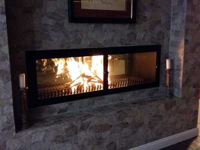 Double-sided built-in fireplace with glass doors